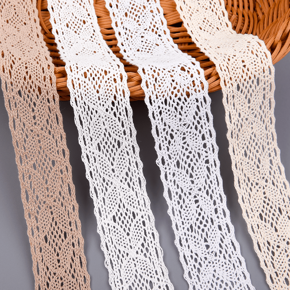 Assorted colors of cotton lace trims with intricate crochet patterns displayed on a woven basket.