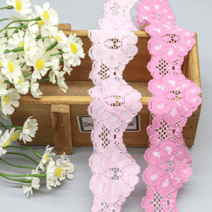 Close-up of two new-design pink stretch lace trims in light and bright shades, featuring soft skin-friendly fabric with full, layered floral patterns and lively wave-shaped edges; elastic and comfortable for bra borders, underwear, and clothing decoration.