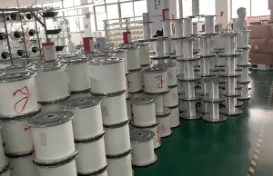 Production line at a lace manufacturer specializing in pure cotton eyelet embroidery with custom durable border options and quality inspection.