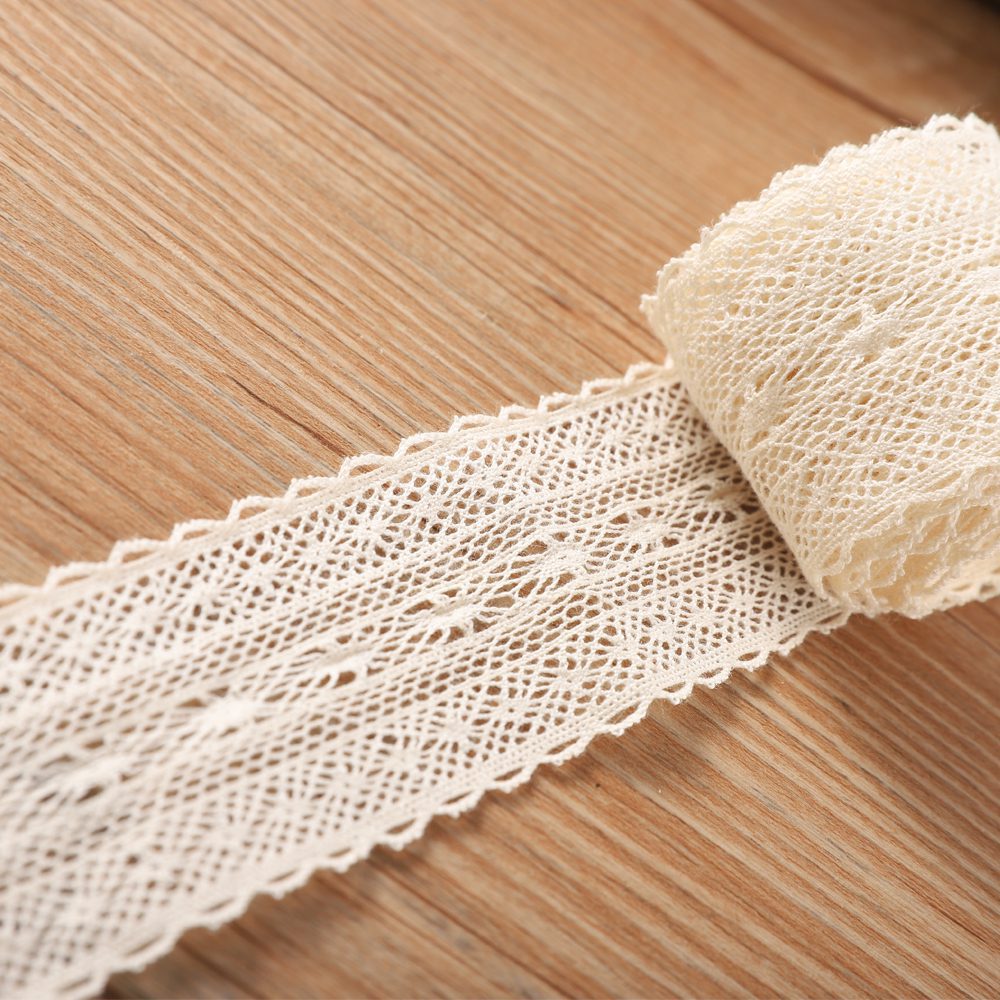 Close-up of elegant beige cotton embroidered lace alongside playful colorful tassel cotton lace trim, highlighting adaptability for curtains, cushions, and bedding designs.