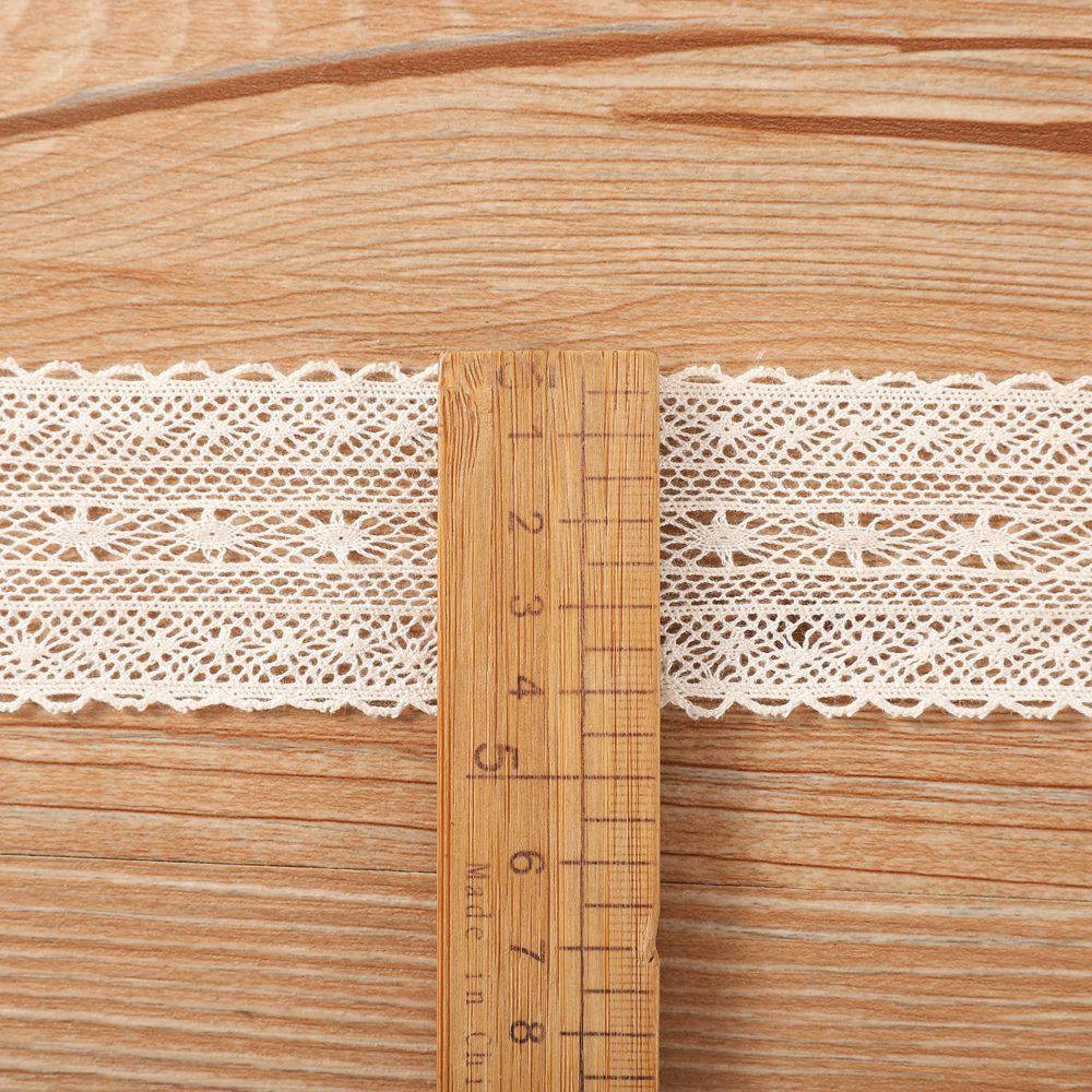 Detailed image of traditional beige cotton lace and a contrasting colorful tassel lace, perfect for ODM projects like table runners or throw pillows.