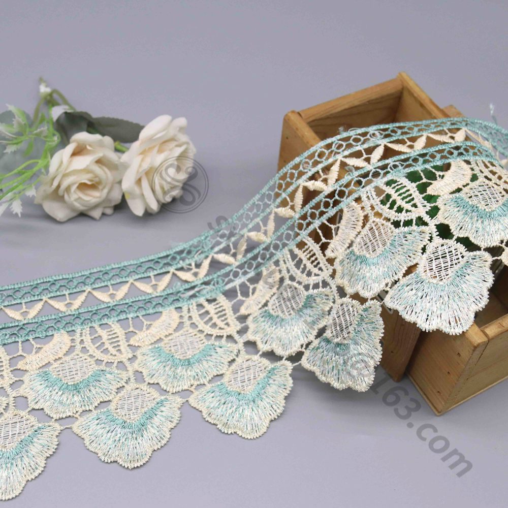 Embroidered water soluble lace trim compared to eyelet fabric panels, providing flexible styling for designer dresses and couture pieces.