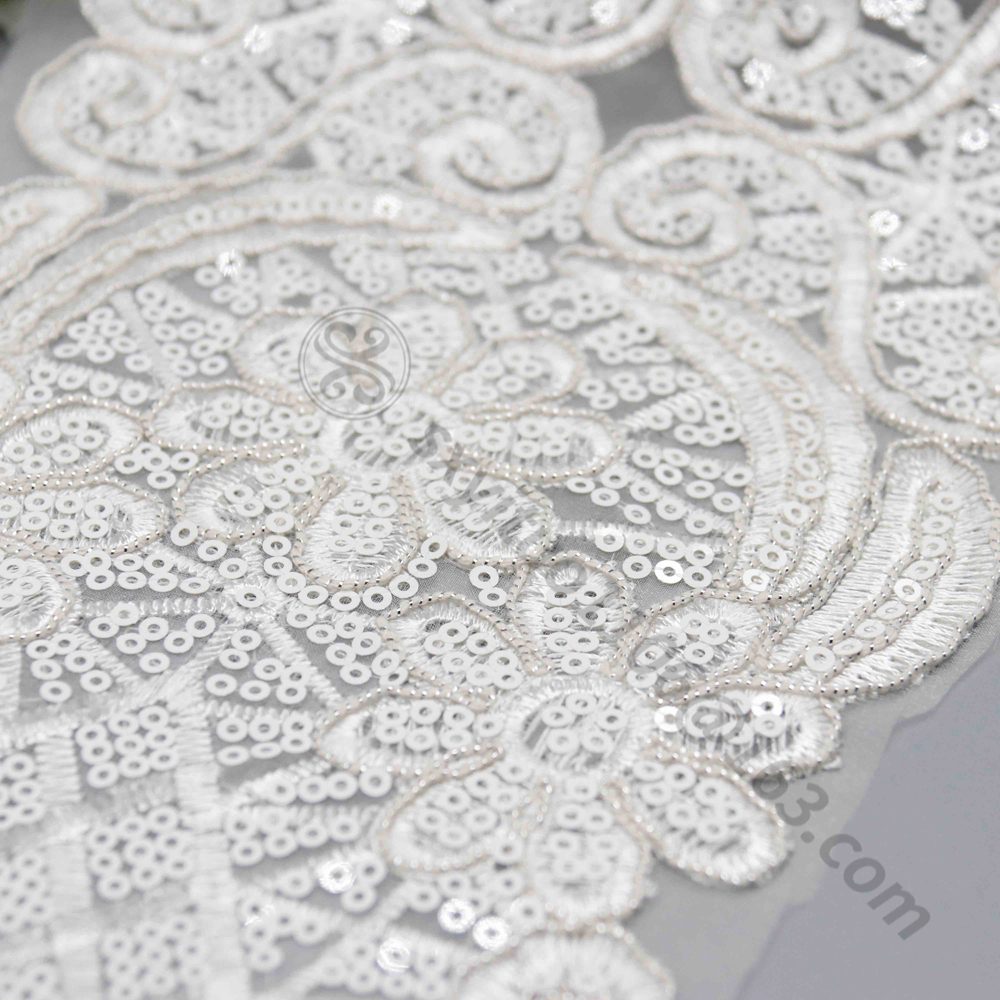 Soft white lace appliqué featuring delicate beadwork and sequins