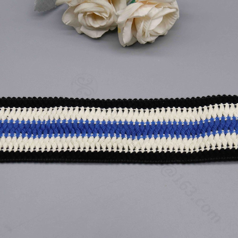 Detailed view of 4.5 cm wide poly cotton canvas webbing with striking black-white-blue blocks, central blue-white weaving, and elegant black lace edges for visual flair; robust and fashionable, suited for bag straps, DIY personalization, and garment embellishments.
