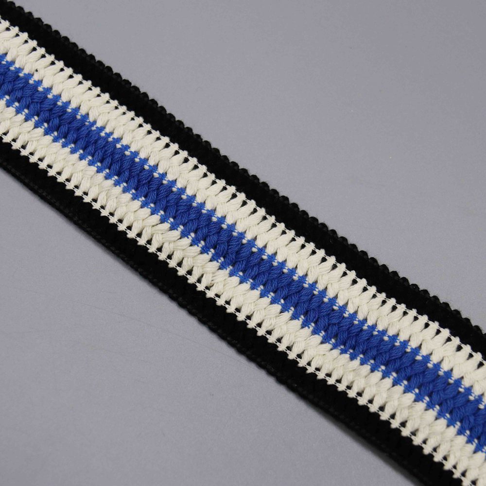 Sophisticated display of 4.5 cm color-blocked webbing in black, white, and blue tones with interwoven blue-white core and decorative black lace trim on edges; fine craftsmanship ensures strength and style for belts, pet leashes, and innovative DIY garment ideas.
