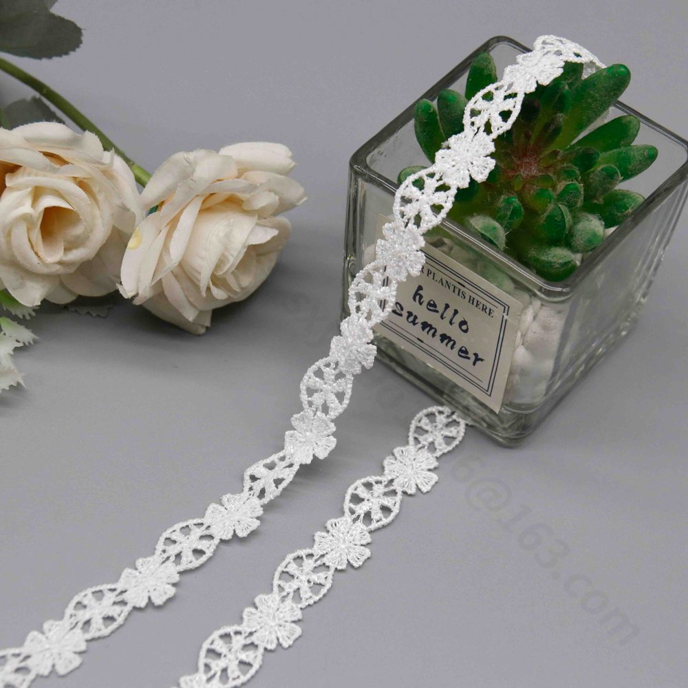 Detailed view of pure white water-soluble embroidered lace trim in a slim strip form, linking stereoscopic six-petal flowers with full, textured embroidery and precise eyelet circular patterns for airy openness; fluid wave edges from seamless connections highlight its embroidery-only structure, perfect for adding delicate romance to bridal dress hems and collars.