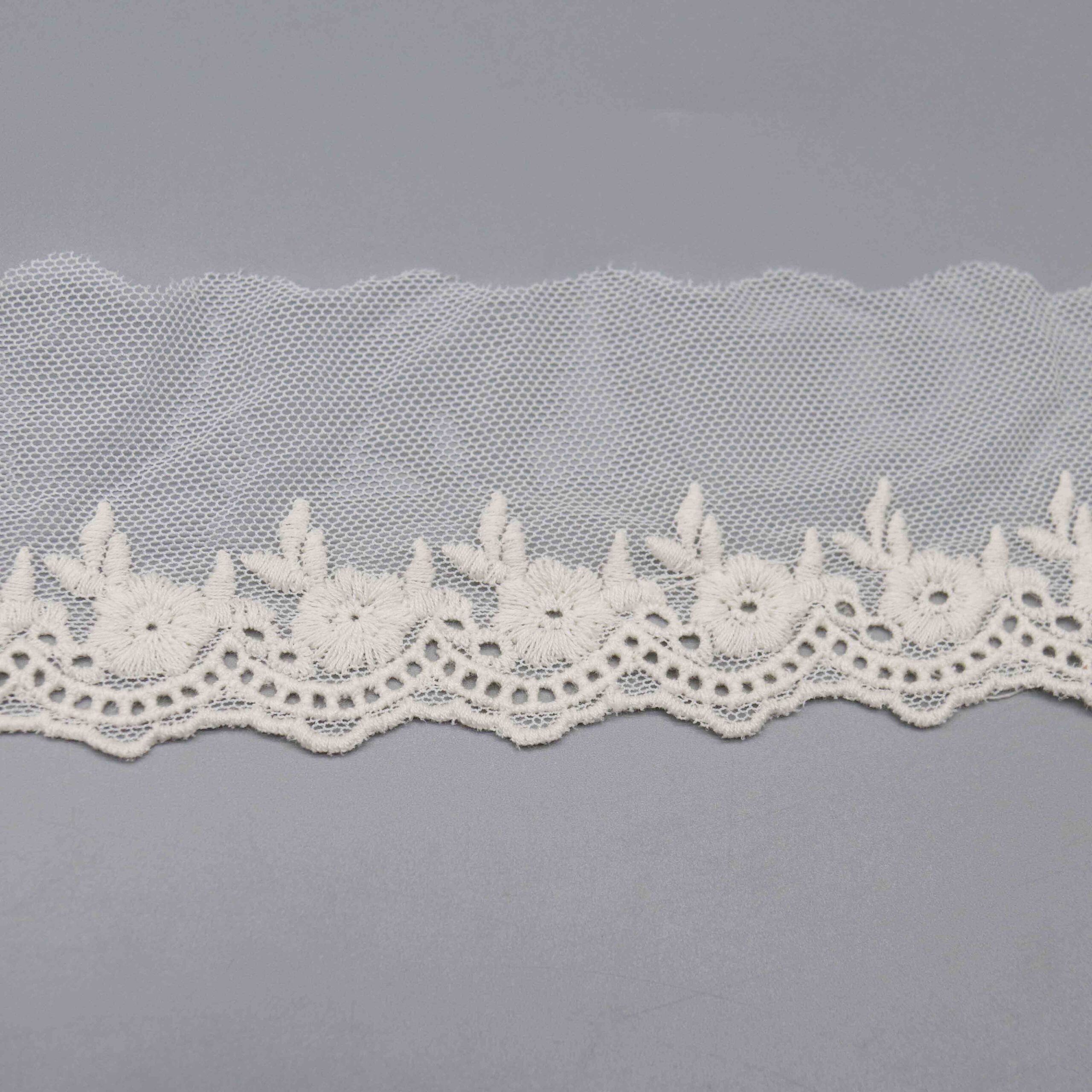 Backlit shot demonstrating the hexagonal mesh transparency and embroidery density contrast.