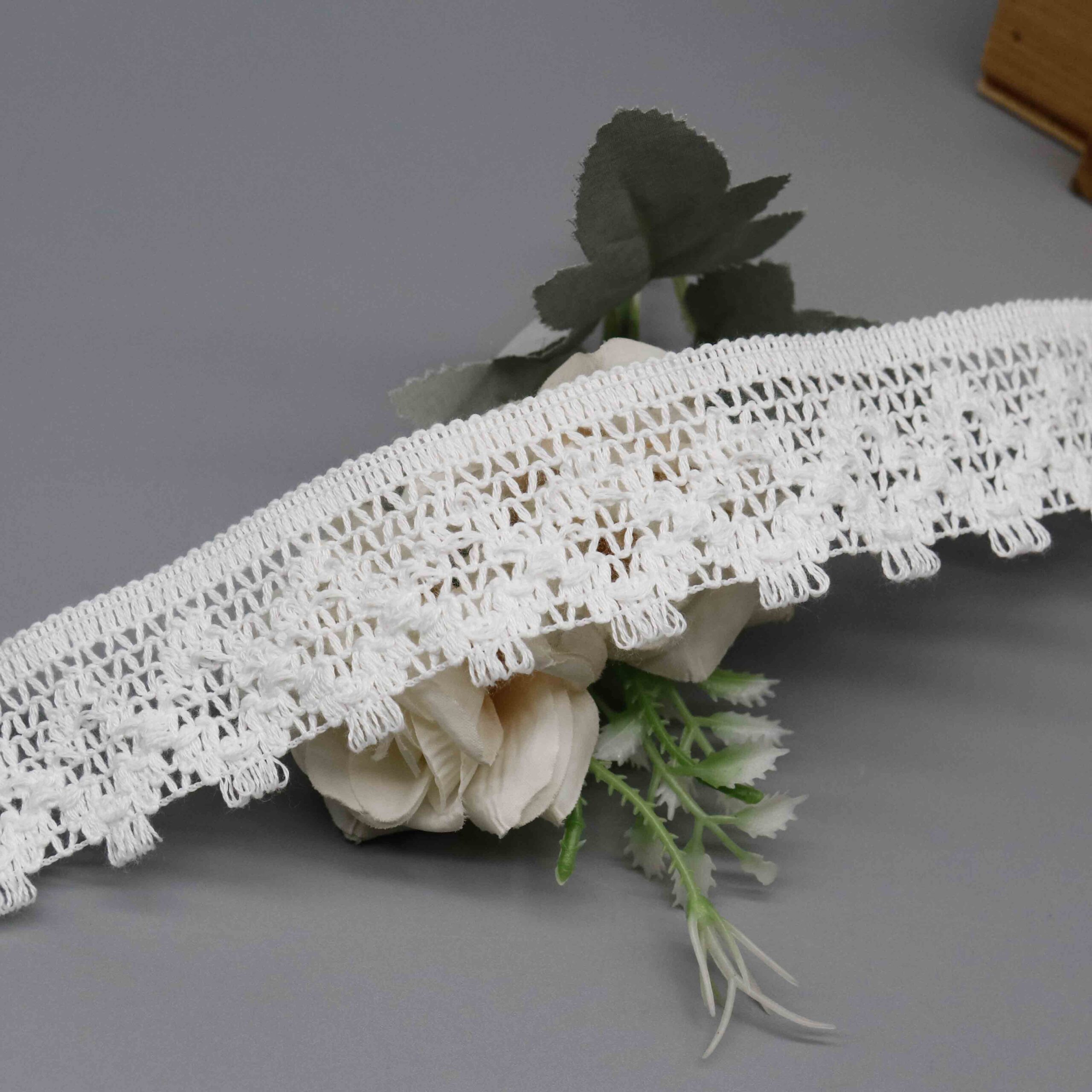 High-resolution focus on the teardrop dangle border and decorative hemline quality.