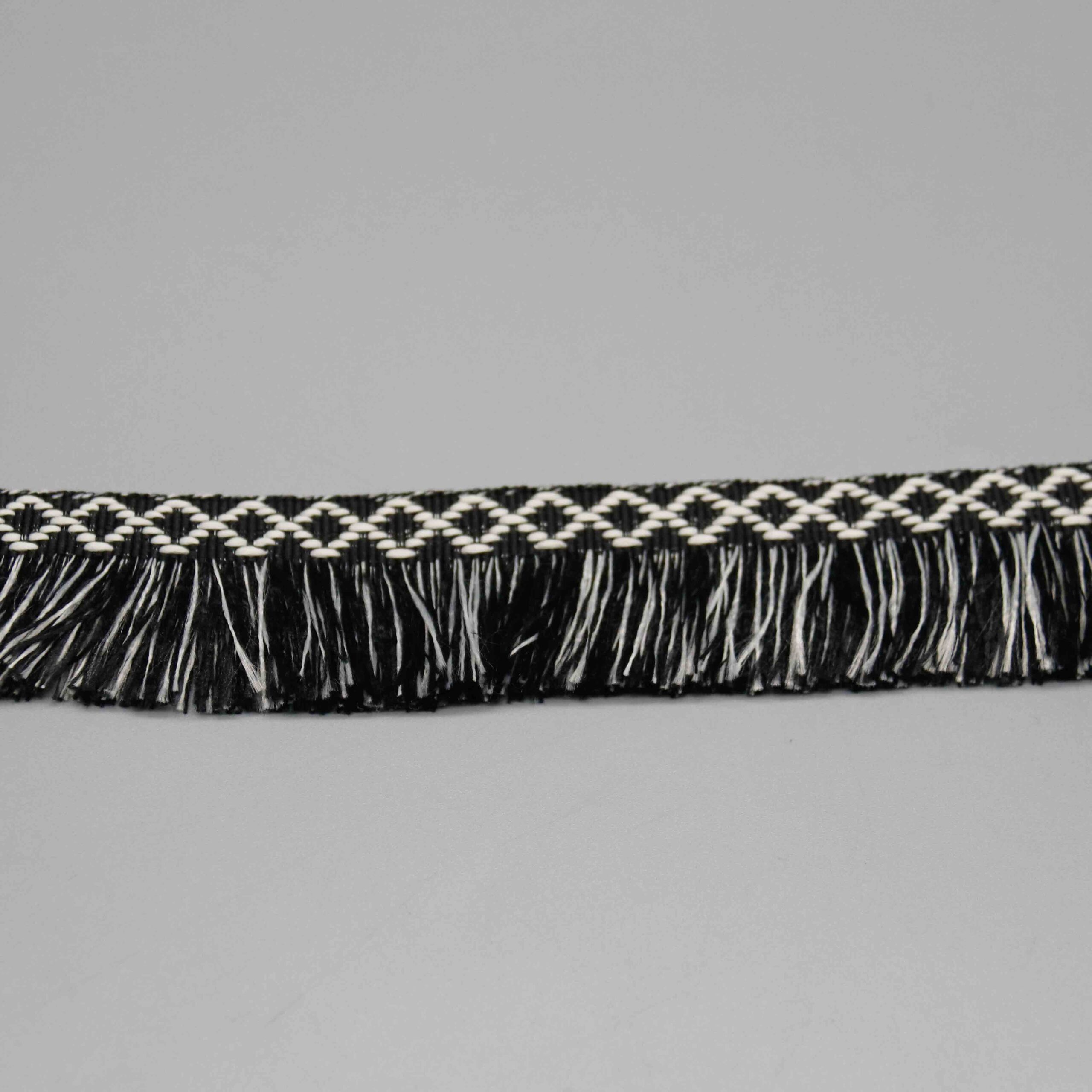 Side-lit shot demonstrating the fringe movement and strand separation of the brush fringe.