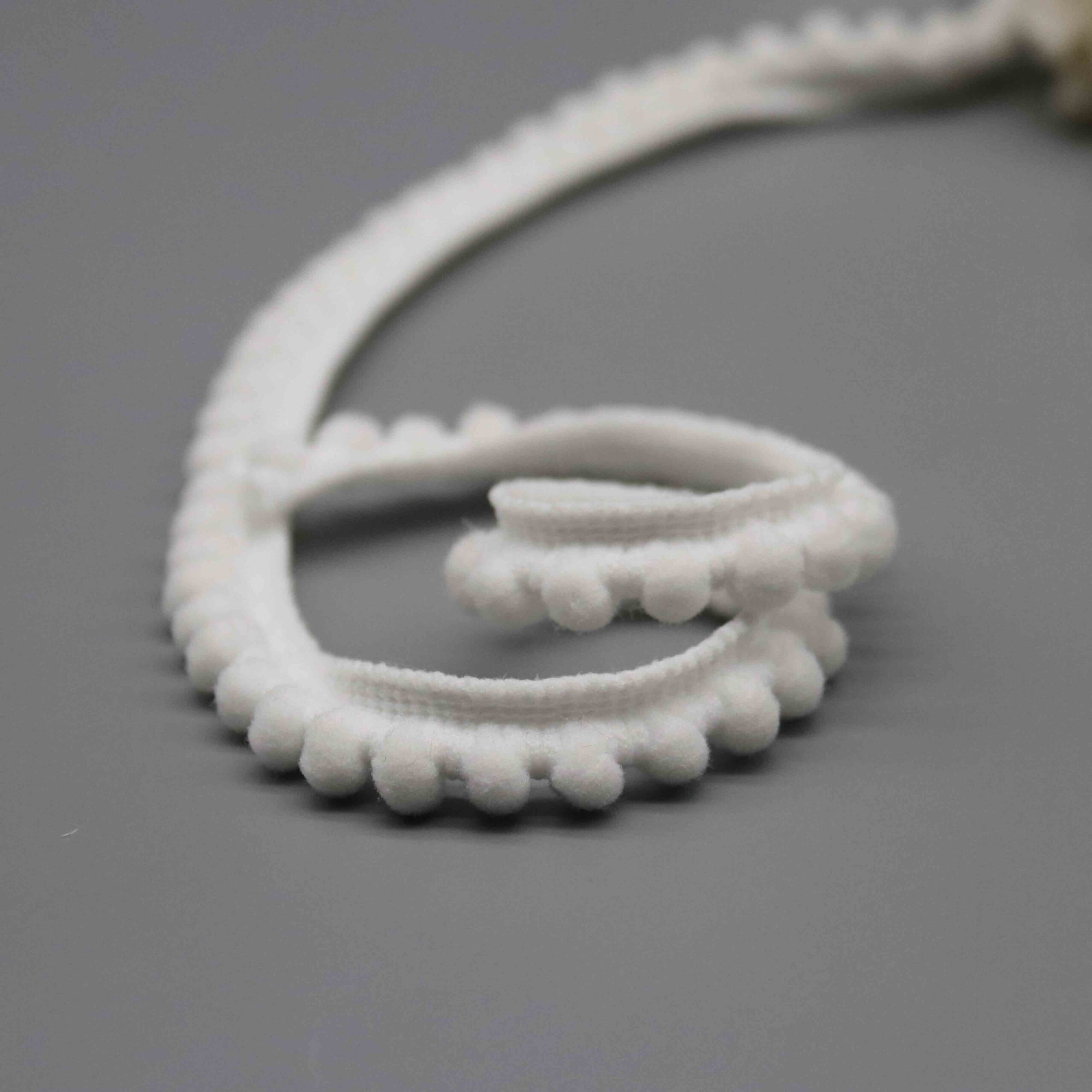 Comparison shot demonstrating the petite 1cm width against a common reference object.