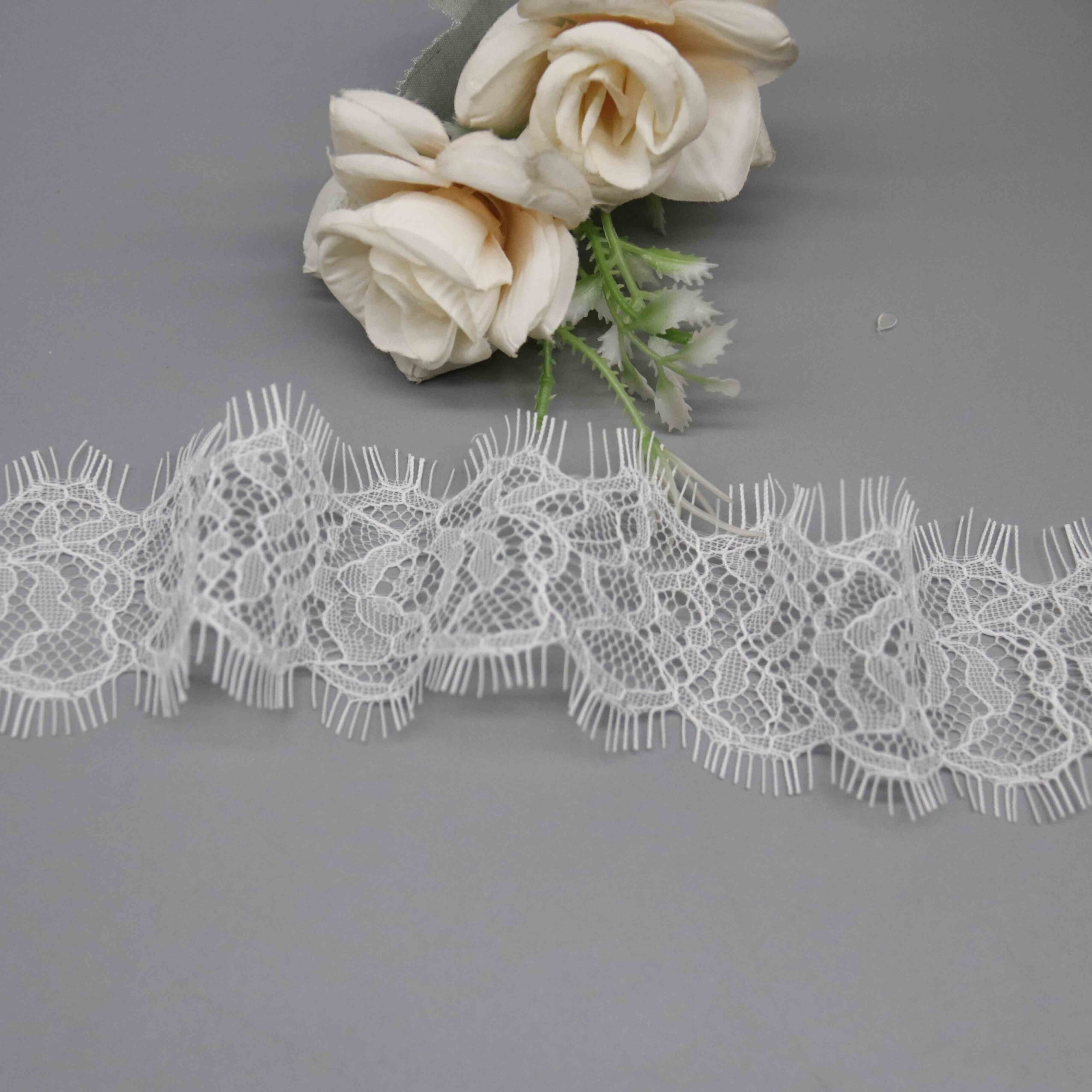 Macro close-up capturing intricate Chantilly motifs and corded thread craftsmanship.