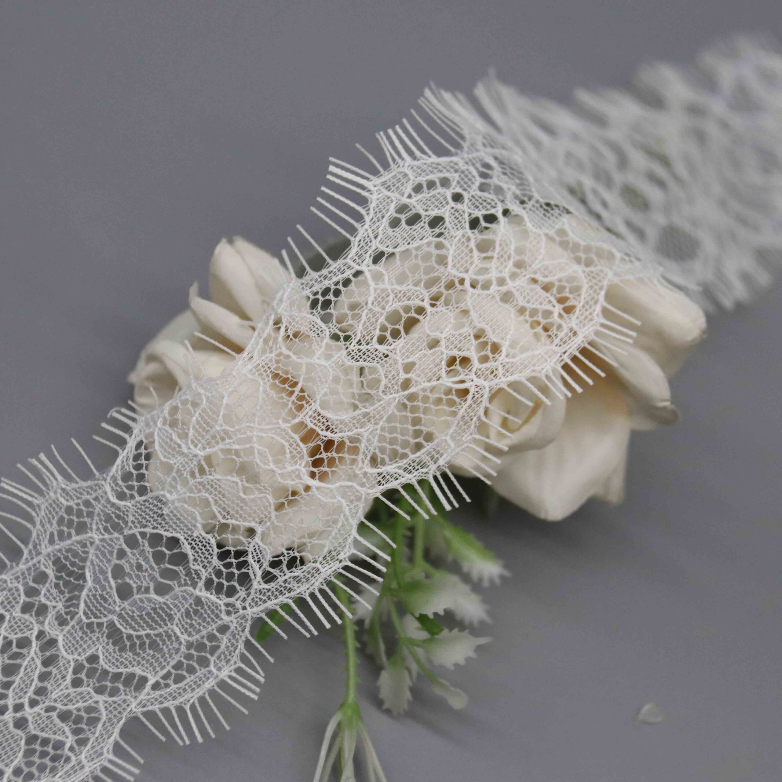 High-resolution focus on the wispy border construction and delicate hemline quality.