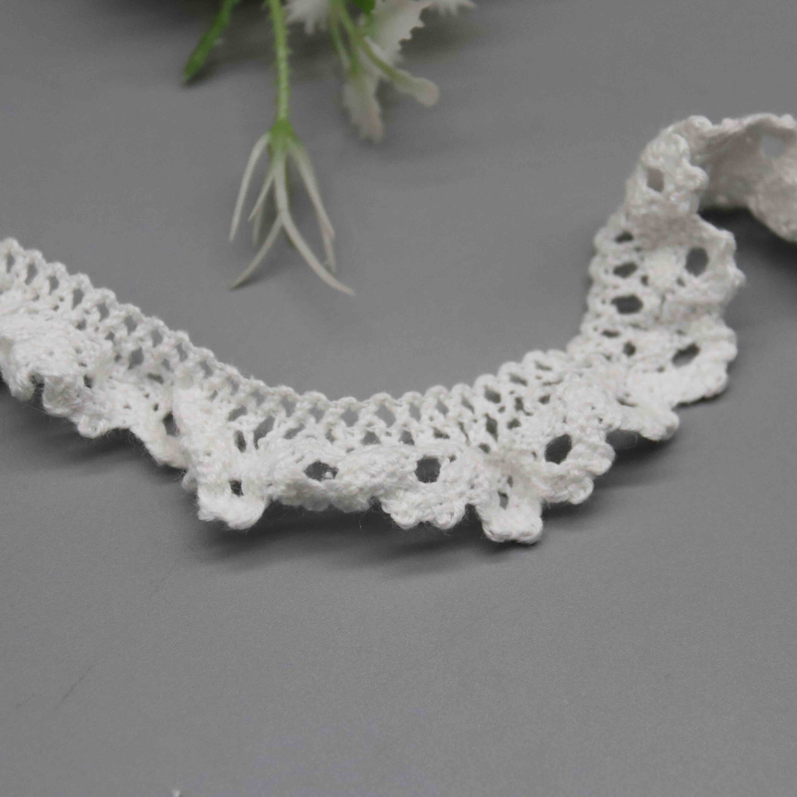 High-resolution focus on the organic curved border and dimensional hemline quality.