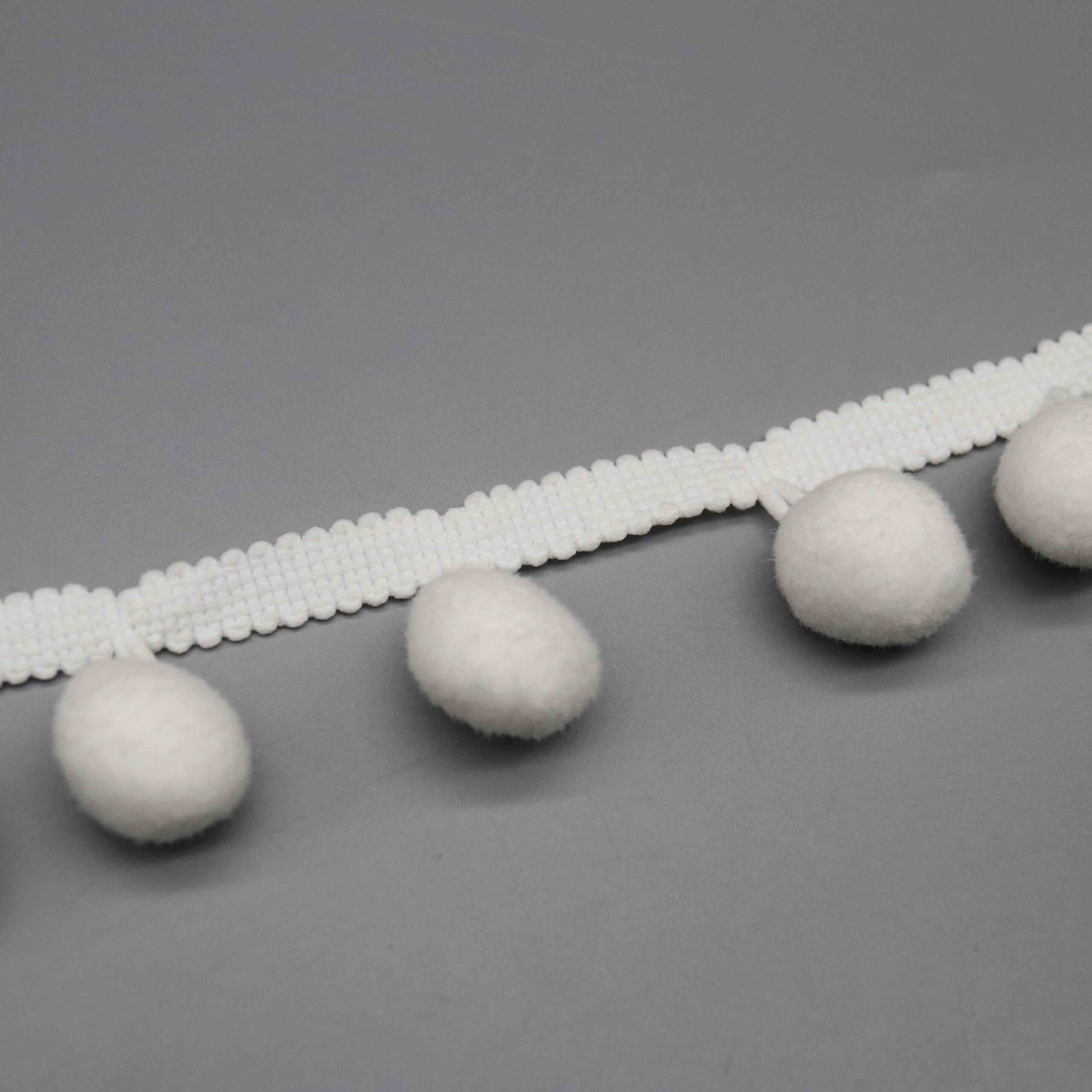 Macro close-up capturing the dense plush texture and spherical shape craftsmanship.