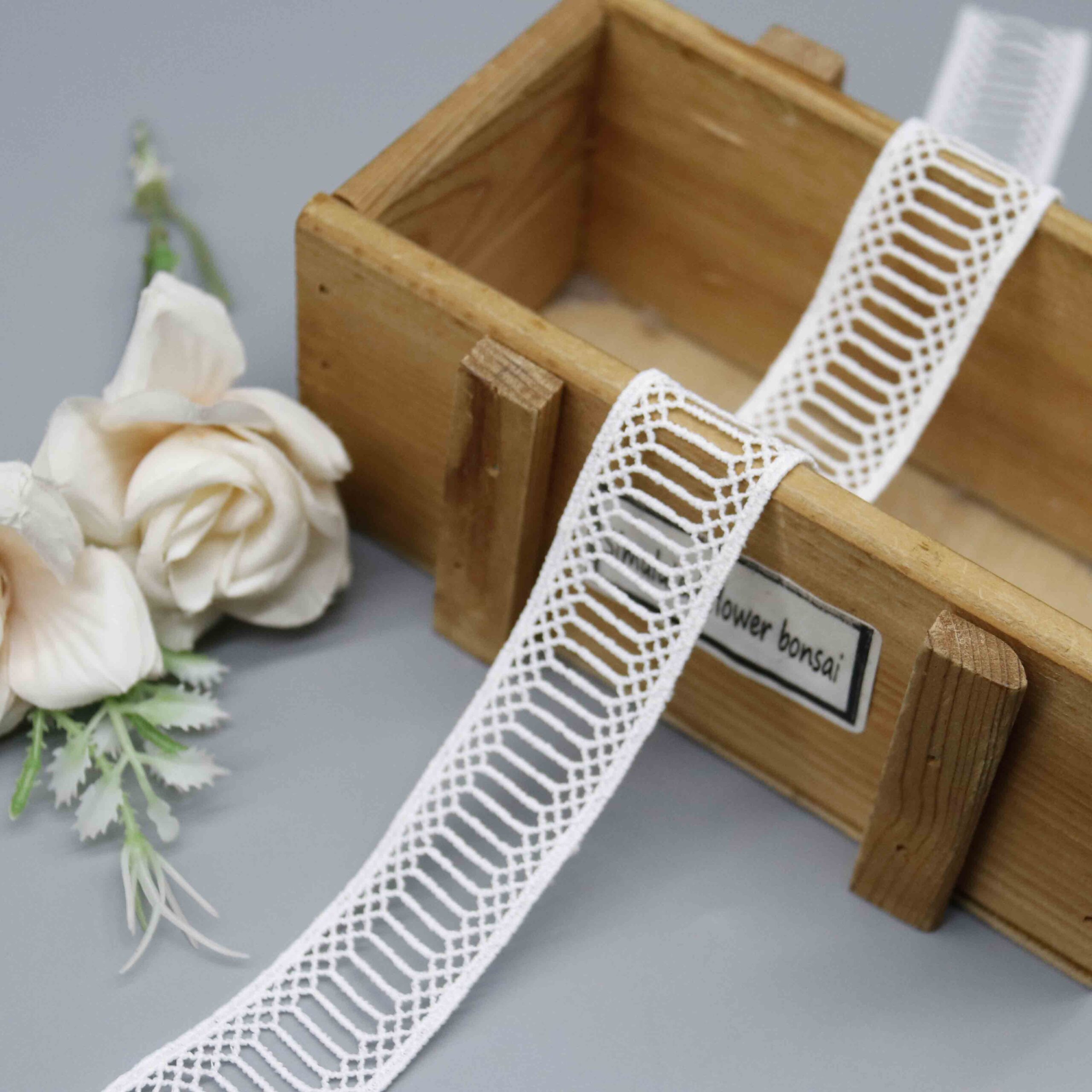 Front-facing shot showing the geometric ladder lace pattern and milk-silk polyester texture clearly.