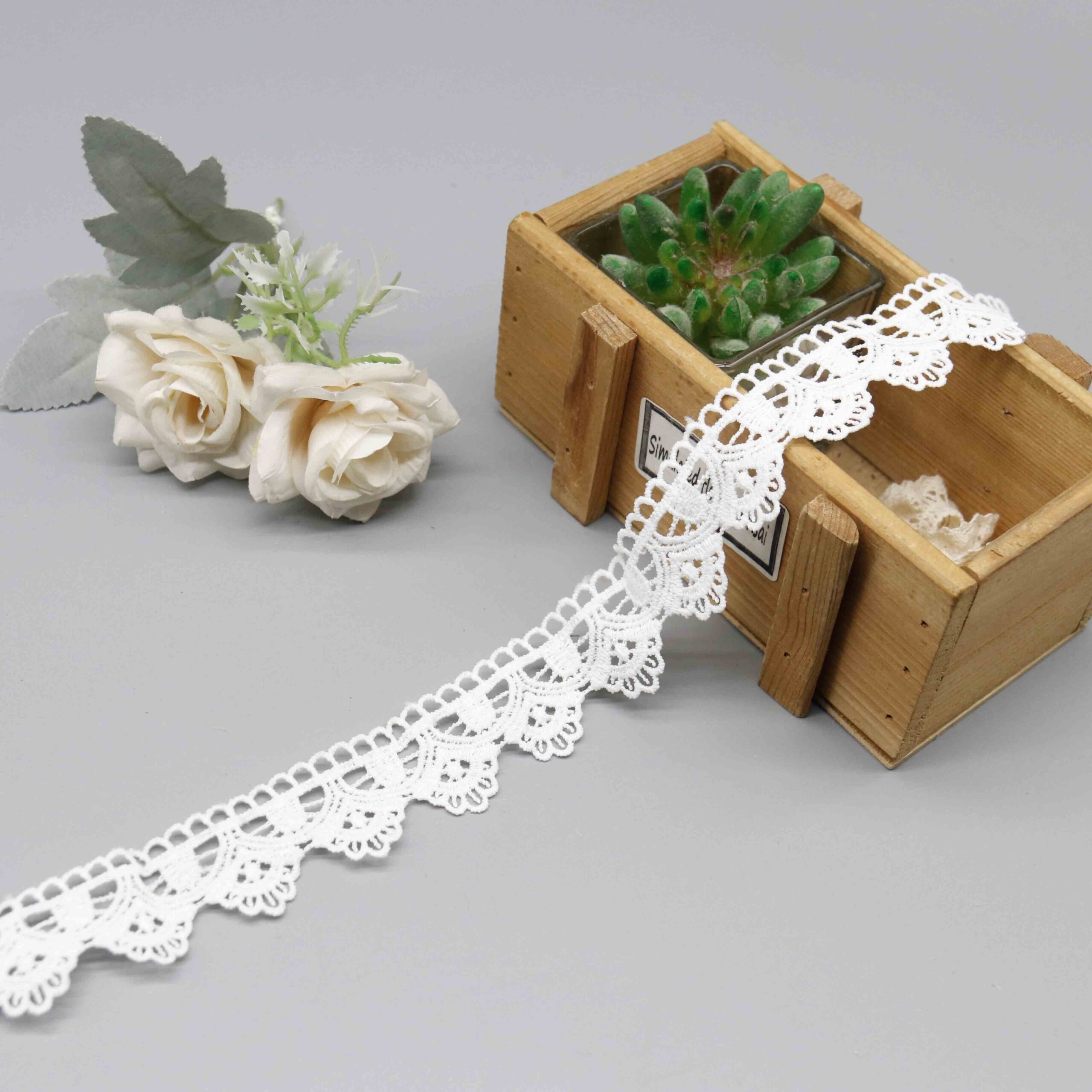Macro close-up capturing intricate scalloped embroidery work and precise thread craftsmanship.