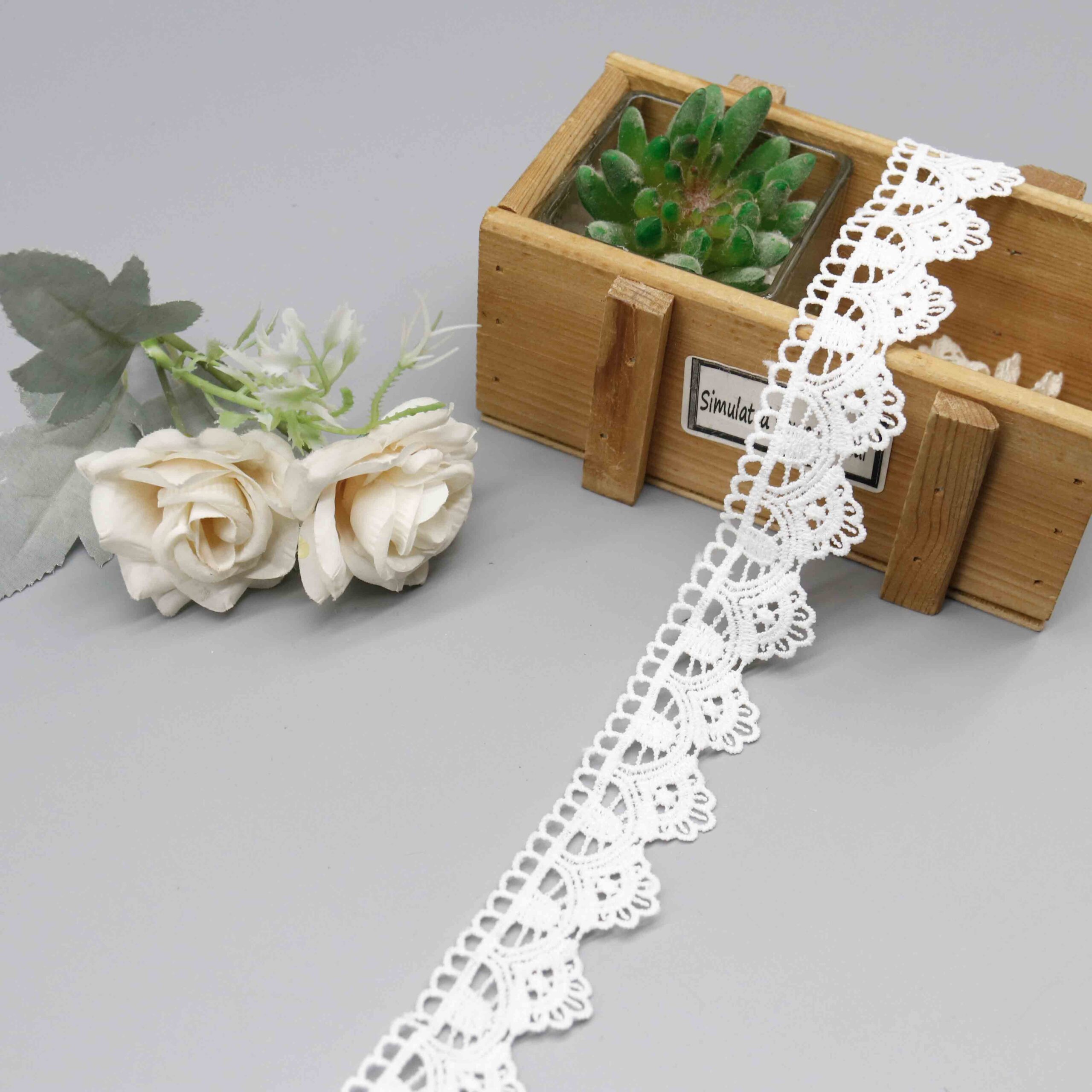 High-resolution focus on decorative loop border construction and refined hemline quality.