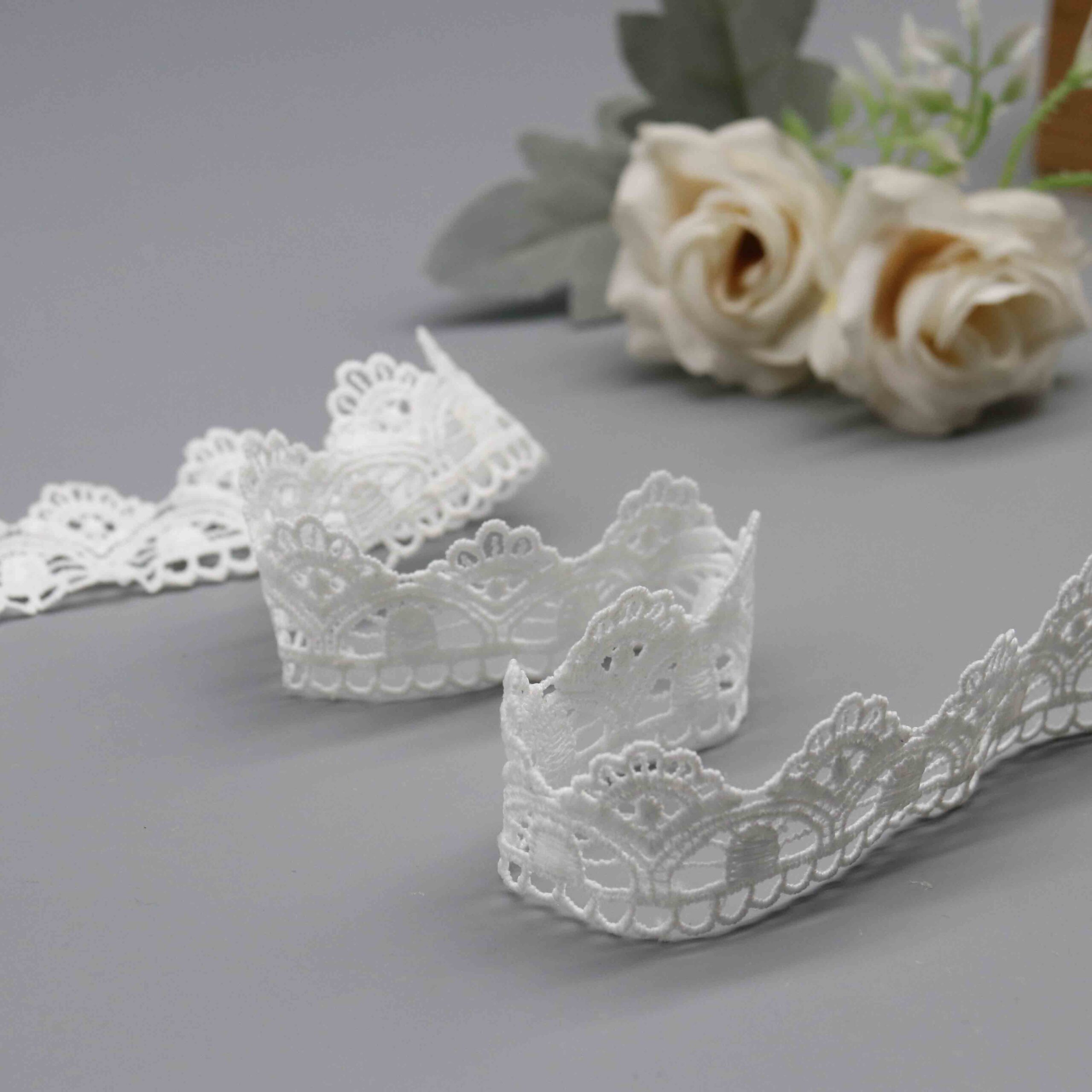 Backlit demonstration of embroidered density and semi-sheer characteristics through fabric mesh.