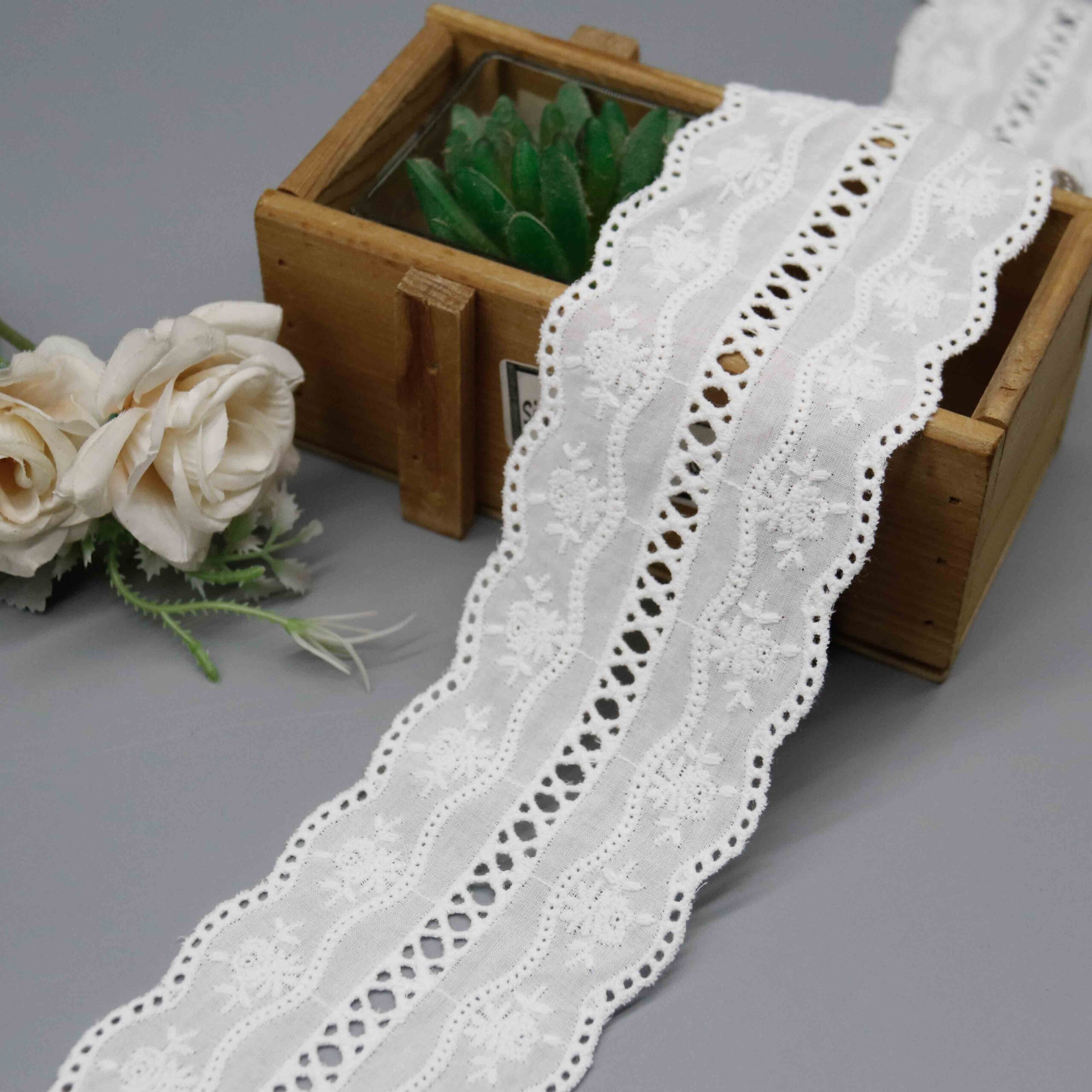 Macro close-up capturing delicate flower sprigs and wave-stitch thread craftsmanship.