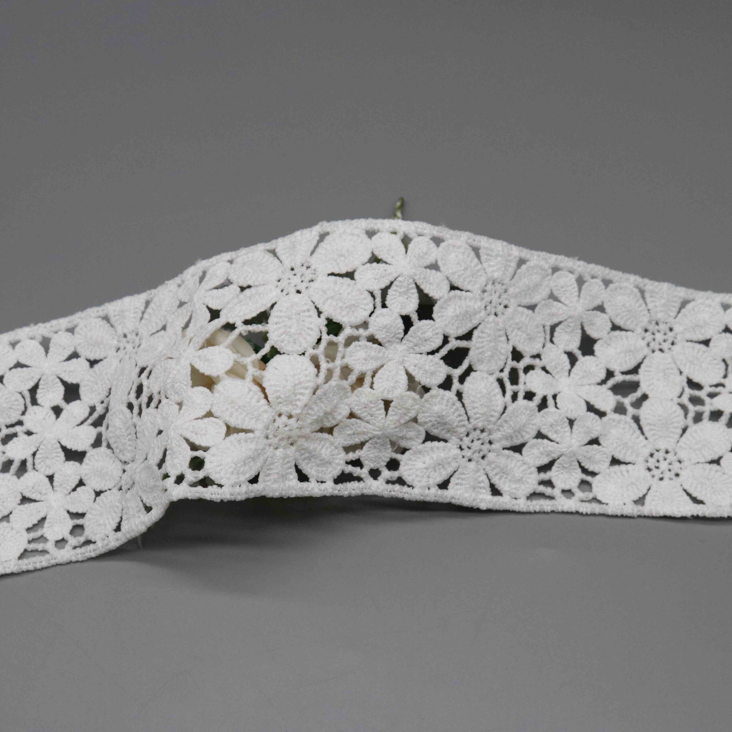 Macro close-up capturing intricate petal formations and raised satin-stitch thread craftsmanship.