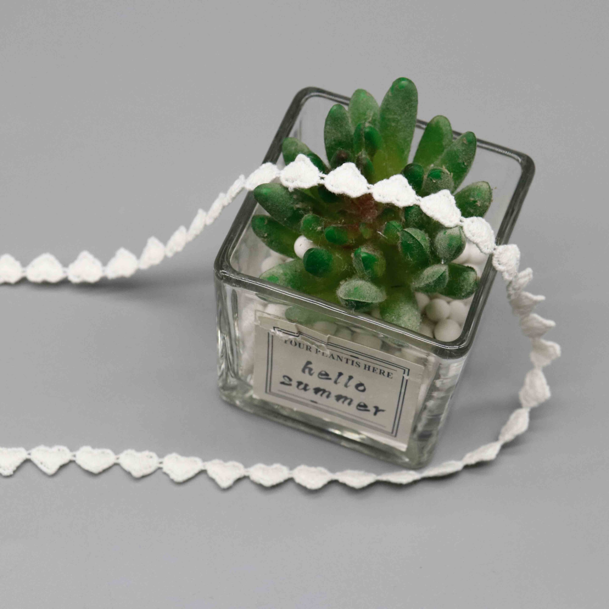 Macro close-up capturing fuzzy heart surfaces and delicate linking thread craftsmanship.