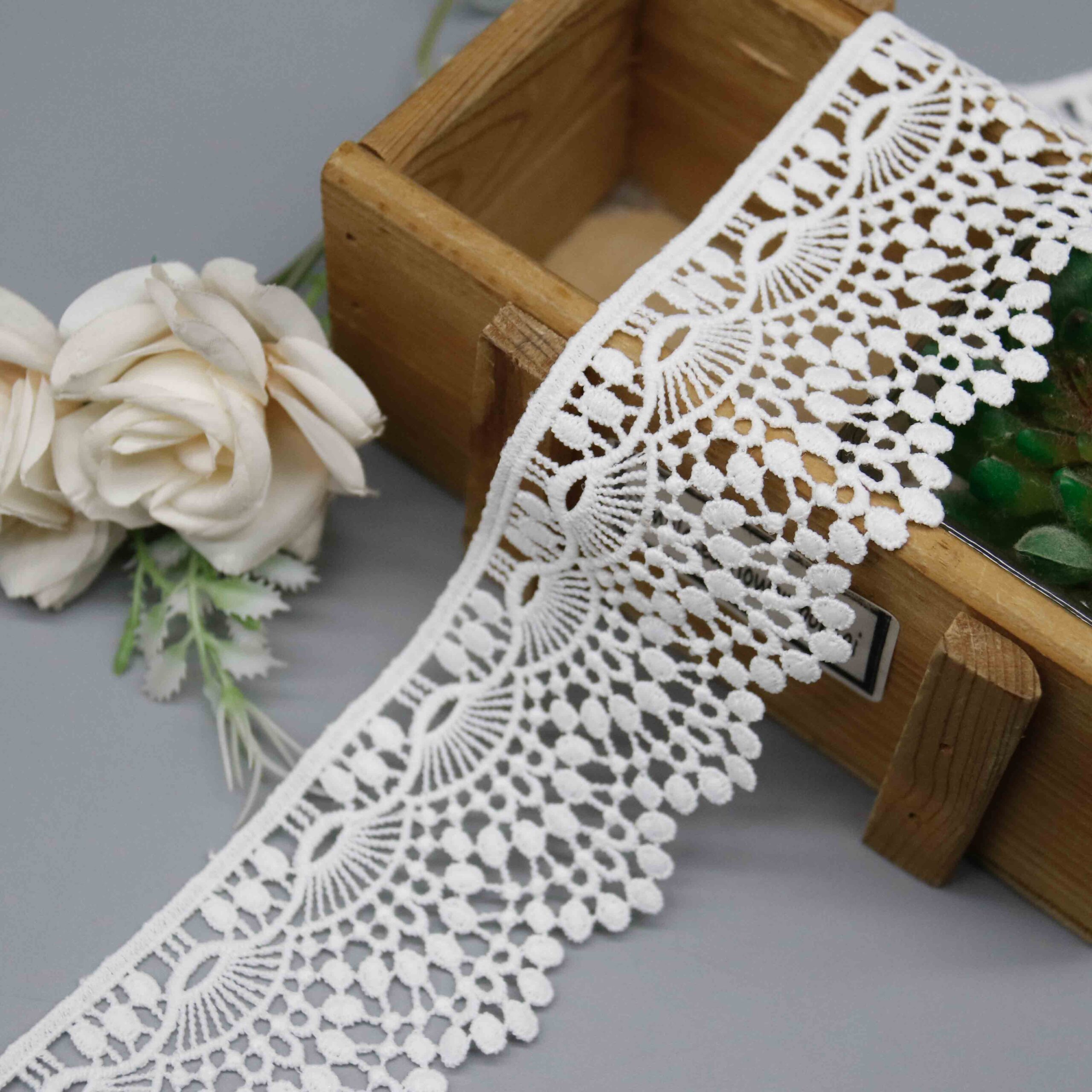 Front-facing shot showing the scalloped fan lace pattern and polyester texture clearly.