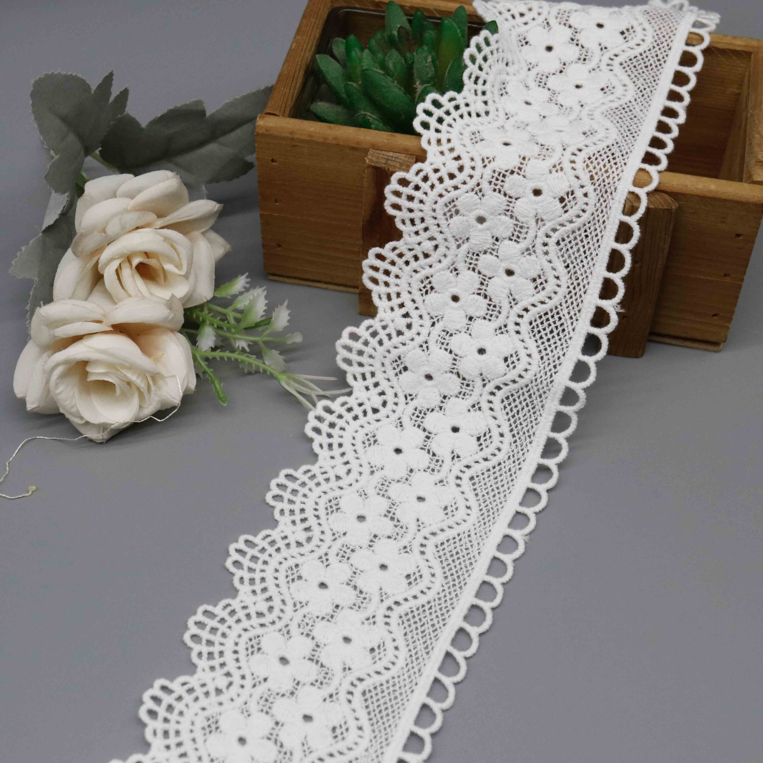 Front-facing shot showing layered zigzag and medallion patterns with soft milk fiber texture on white water-soluble lace.