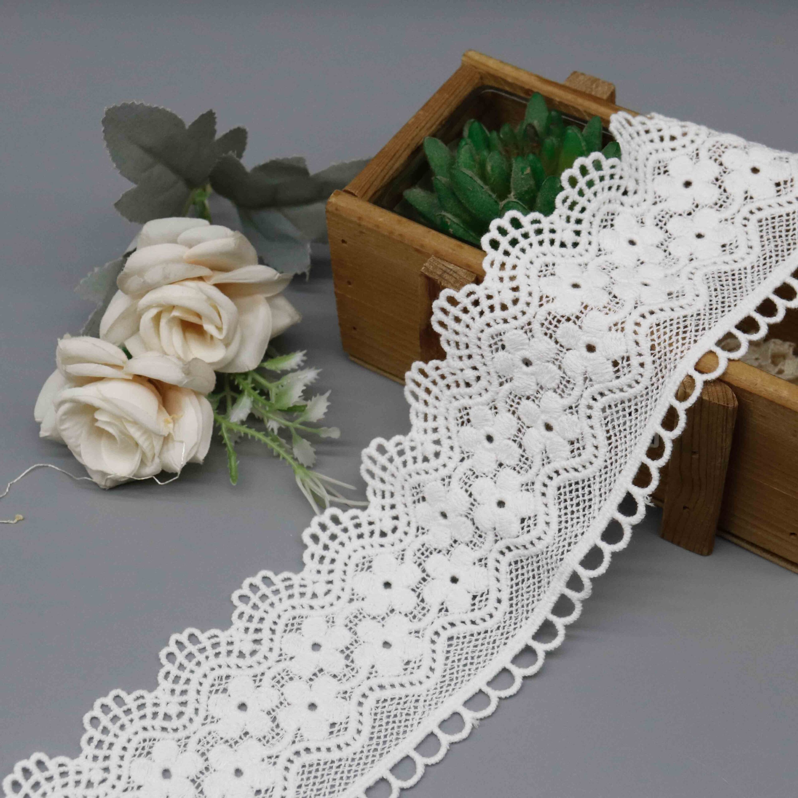 Macro close-up capturing intricate flower motifs and delicate openwork thread craftsmanship.