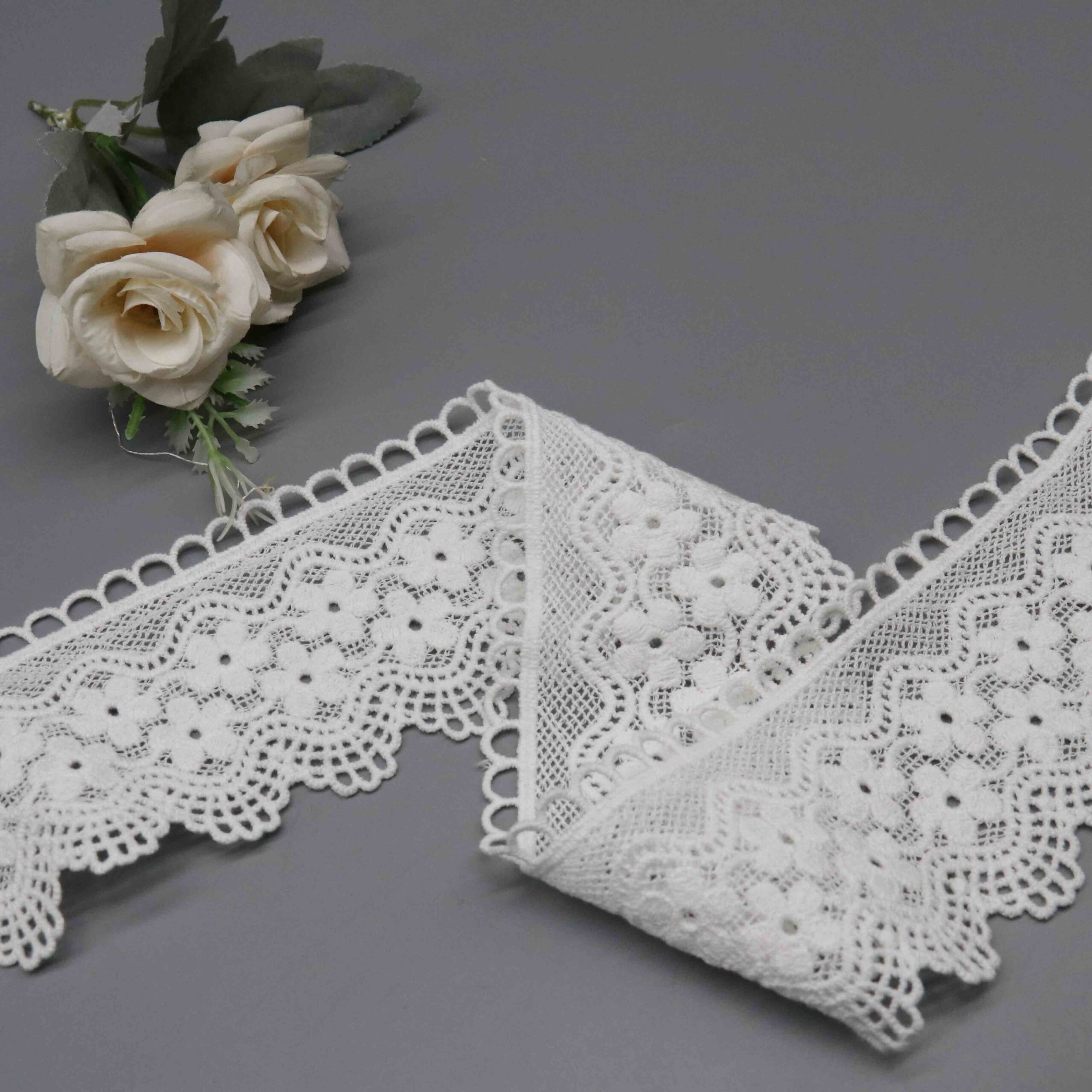 High-resolution focus on elongated fan border construction and picot loop edging quality.
