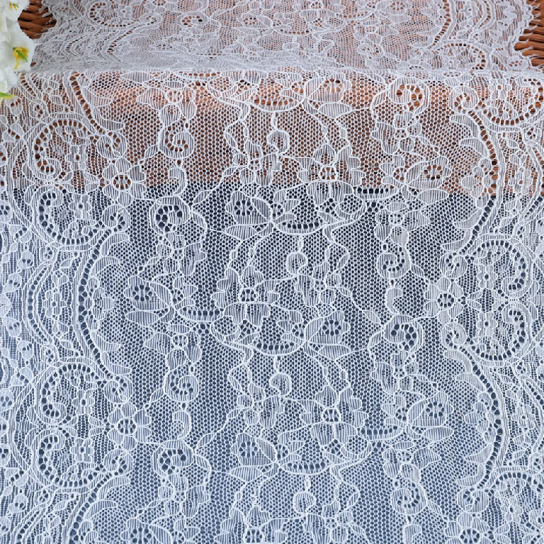 Flexible and beautifully designed mesh lace trim blending nylon and spandex, ideal for use in wedding dress crafting.