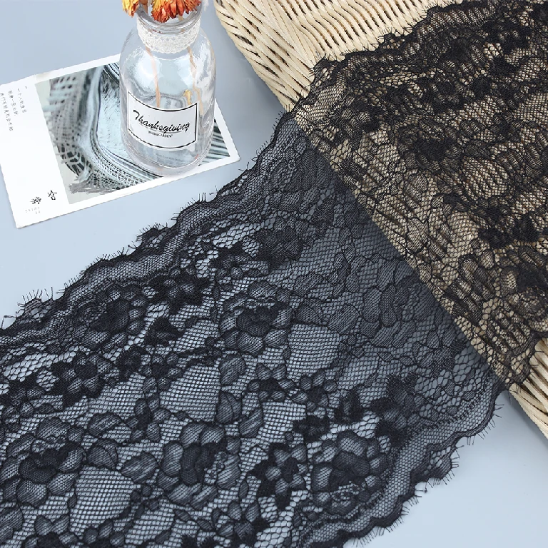 Black eyelash lace trim with detailed floral patterns and fine fringed eyelash edges, approximately 21 cm wide.