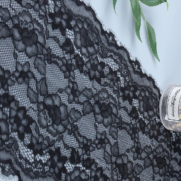 Black eyelash lace trim with intricate floral and wavy designs, approx. 21 cm wide, suitable for fashion and decor.